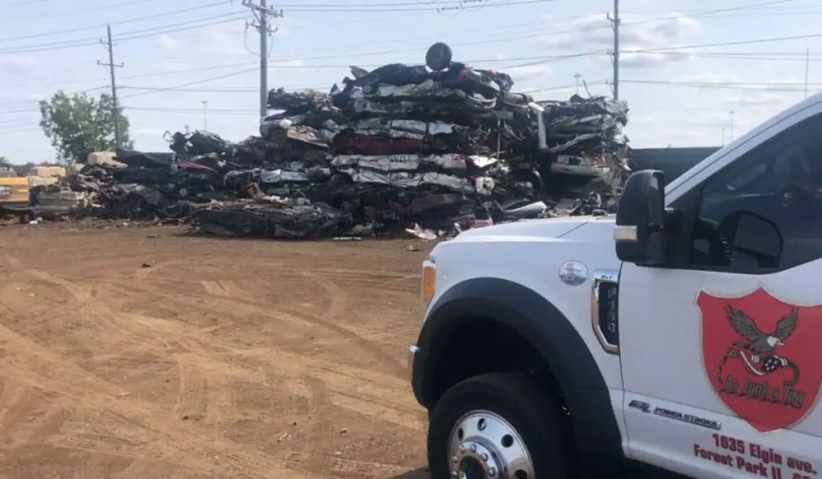 a white towing truck in a junkyard