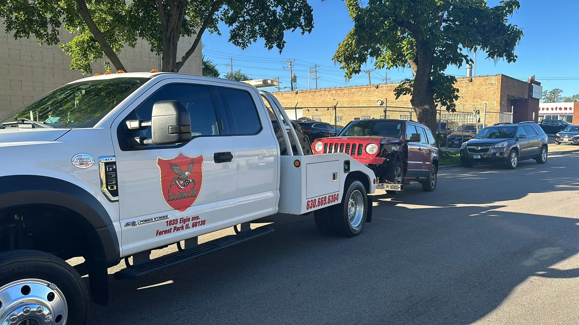 Tow truck picking up a Junk Car in 2026 from a residential street