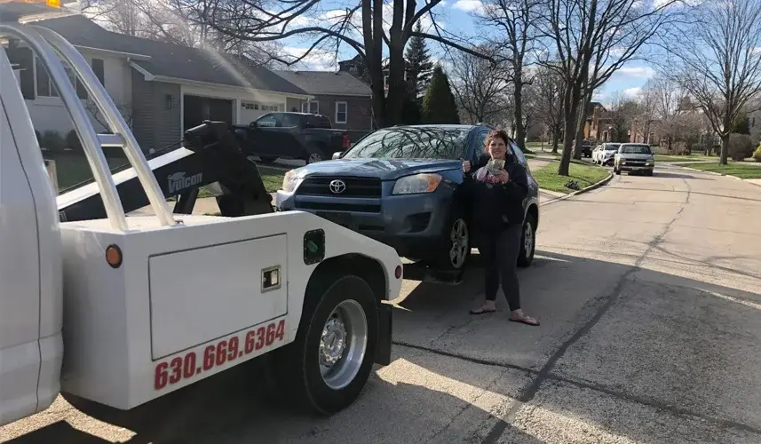 A woman sells her junk car for cash.