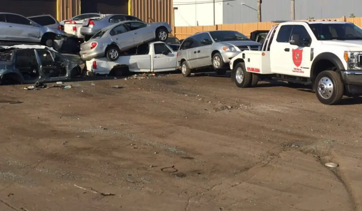 Stacked junk vehicles in removal yard showing bulk pickup options for those who sell multiple junk cars.