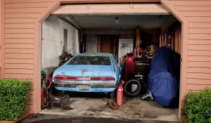 Non-running car in Bellwood garage, stuck without title, waiting for junk vehicle pickup service.