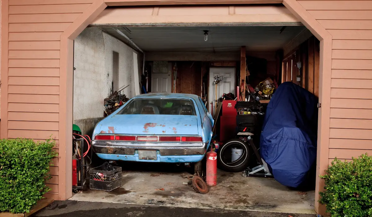 Non-running car in Bellwood garage, stuck without title, waiting for junk vehicle pickup service.