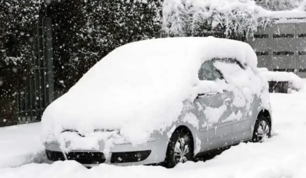 Snow-covered vehicle in Elmhurst showing clear signs it's time to scrap your old car this winter.