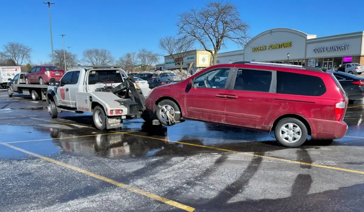 Car That Doesn’t Run getting removed from snowy suburban parking lot after winter mechanical vehicle failure.